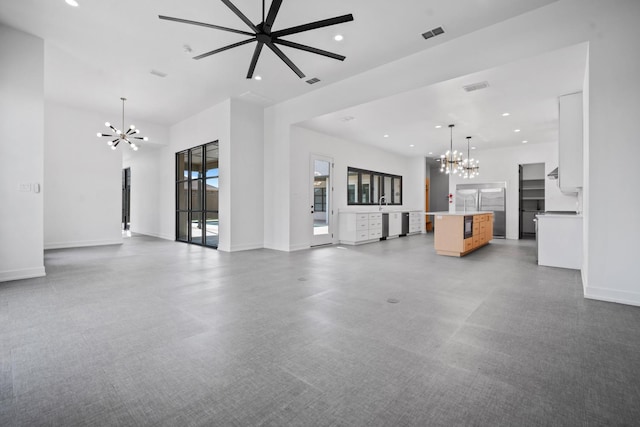 unfurnished living room with an inviting chandelier