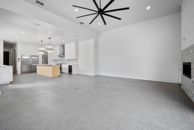 unfurnished living room featuring a chandelier