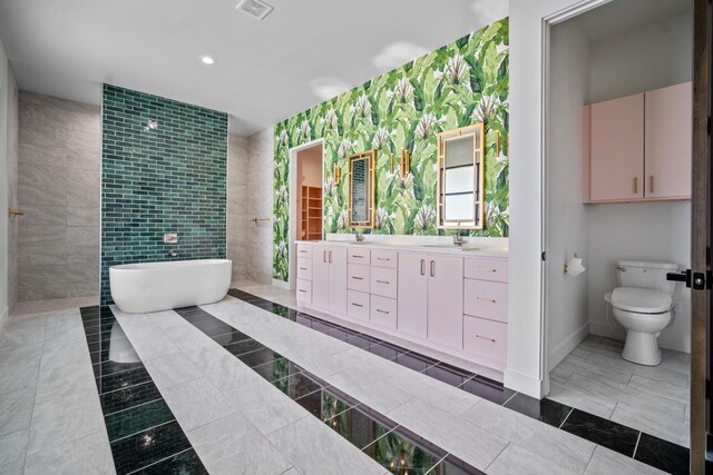 bathroom with vanity, a bath, tile patterned floors, and toilet