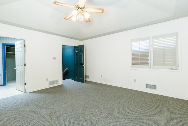 unfurnished bedroom featuring carpet flooring, ceiling fan, and a tray ceiling