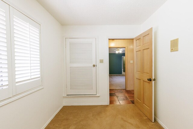 hallway featuring light colored carpet