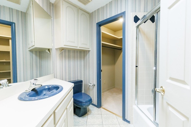 full bathroom with vanity, tile patterned floors, shower / bath combination with glass door, and toilet