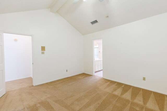 carpeted spare room featuring lofted ceiling with beams and ceiling fan