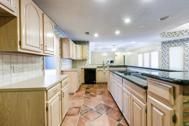 kitchen featuring sink, black dishwasher, decorative backsplash, ceiling fan, and light brown cabinets