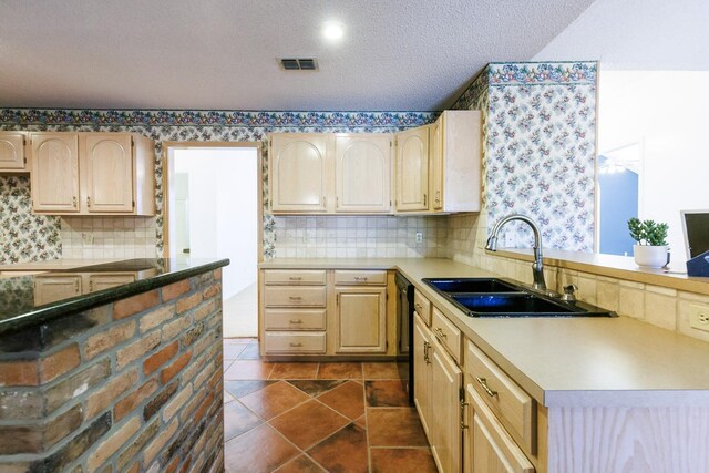 kitchen with dishwasher, sink, decorative backsplash, light brown cabinets, and a textured ceiling