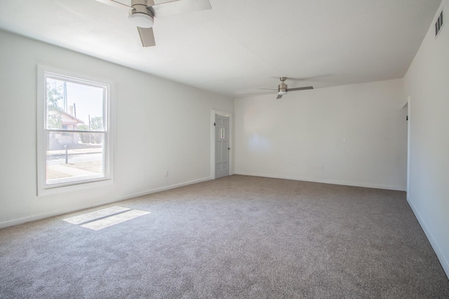 carpeted empty room featuring ceiling fan