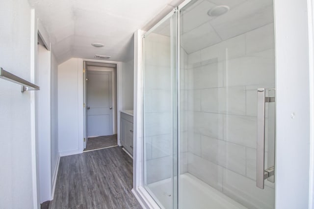 bathroom featuring vanity, hardwood / wood-style floors, and walk in shower