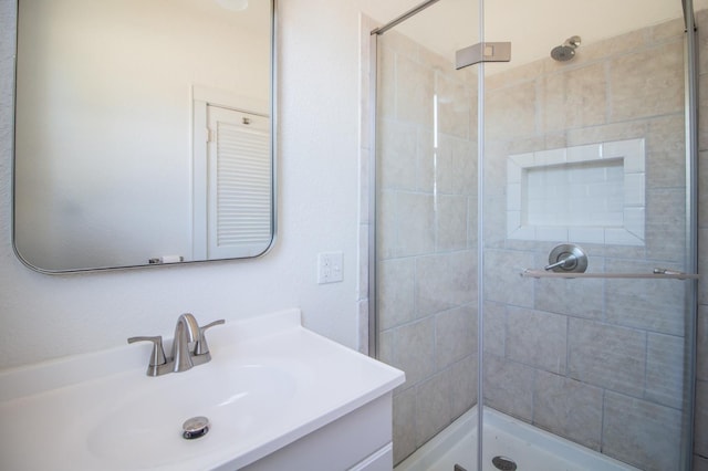 bathroom featuring vanity and tiled shower