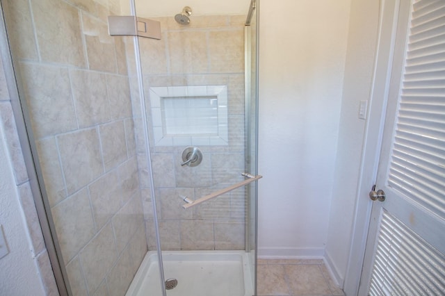 bathroom featuring a shower with shower door