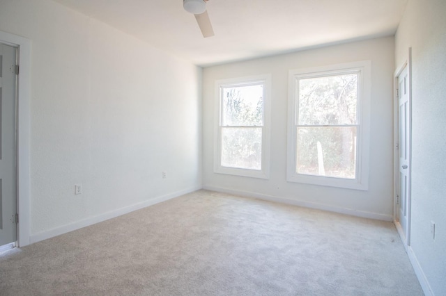 carpeted empty room featuring ceiling fan