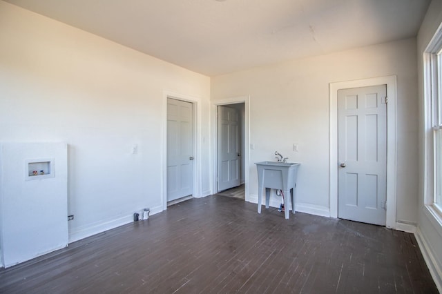 interior space featuring hookup for a washing machine and dark hardwood / wood-style floors