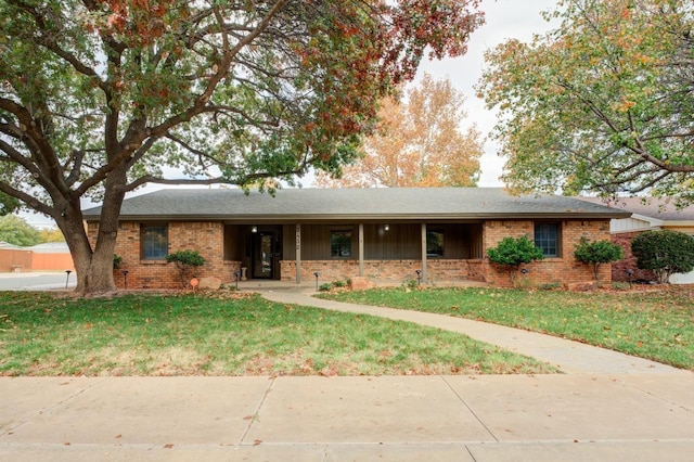 ranch-style home featuring a front yard