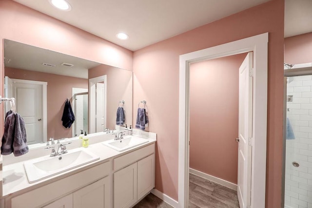 bathroom with vanity, hardwood / wood-style floors, and a shower