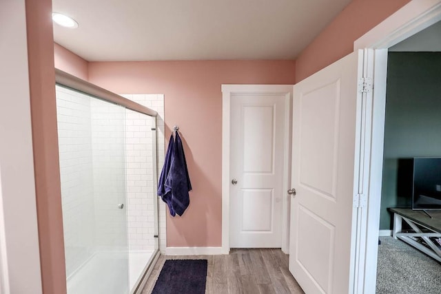 bathroom with wood-type flooring and walk in shower