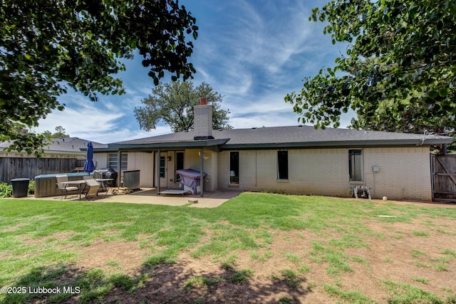 3312 86th St, Lubbock, TX 79423 - back of property with a patio, brick siding, and a chimney