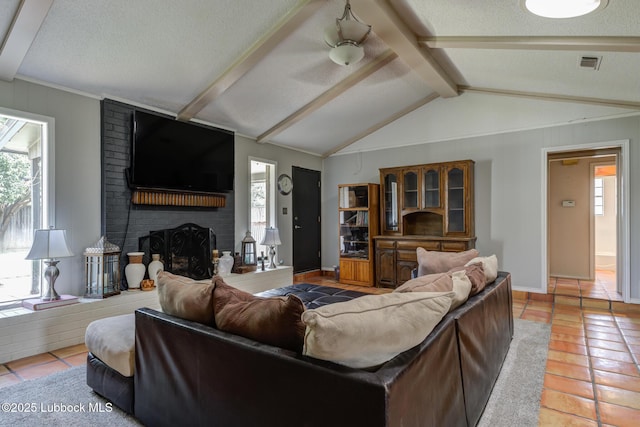 3312 86th St, Lubbock, TX 79423 - living area featuring healthy amount of natural light, light tile patterned floors, a fireplace, baseboards, and a textured ceiling