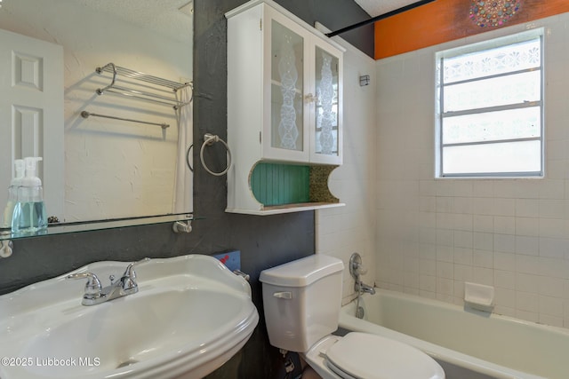 3312 86th St, Lubbock, TX 79423 - bathroom with a sink, toilet, shower / washtub combination, and a textured ceiling