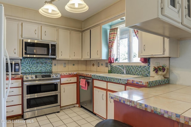 3312 86th St, Lubbock, TX 79423 - kitchen featuring stainless steel appliances, a sink, tasteful backsplash, and light countertops