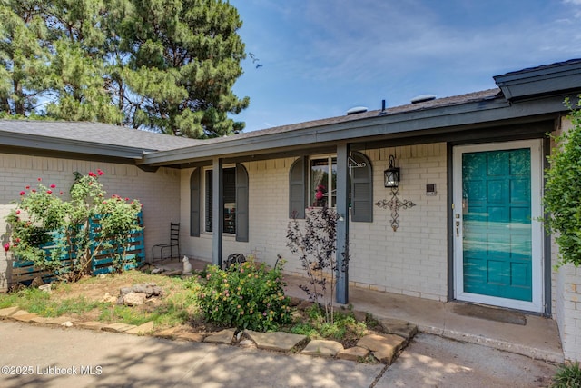 3312 86th St, Lubbock, TX 79423 - doorway to property featuring brick siding and covered porch