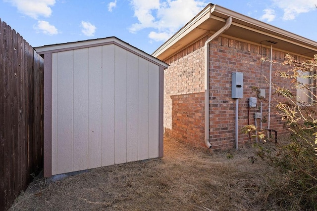 view of side of home with a storage shed