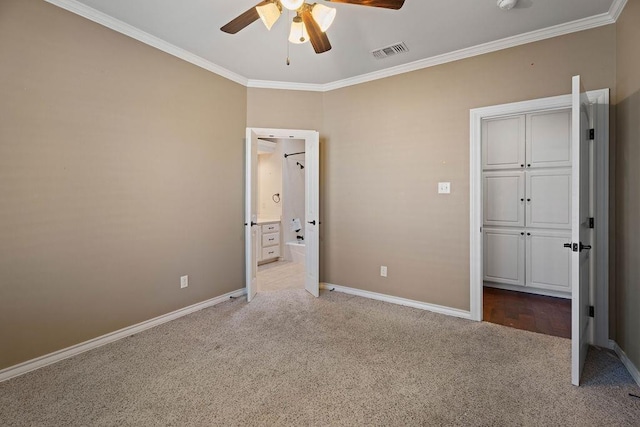 unfurnished bedroom featuring crown molding, light colored carpet, ceiling fan, and ensuite bath