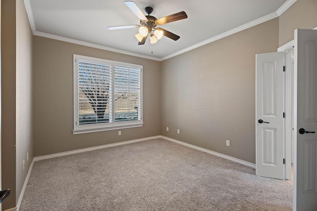 carpeted spare room with ornamental molding and ceiling fan