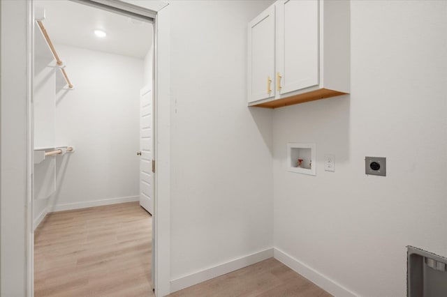 laundry area with cabinets, hookup for a washing machine, hookup for an electric dryer, and light hardwood / wood-style flooring