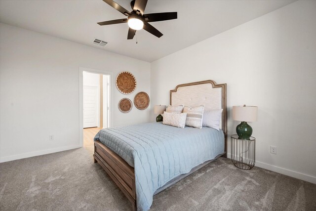 empty room featuring ceiling fan and light carpet