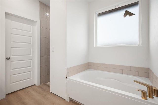 bathroom featuring hardwood / wood-style floors and a tub