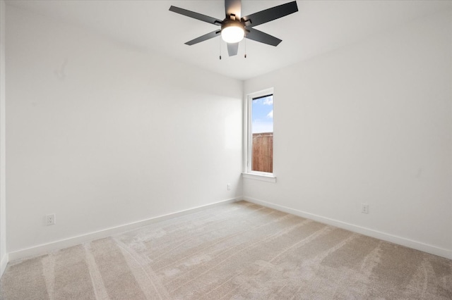 unfurnished room with light colored carpet and ceiling fan