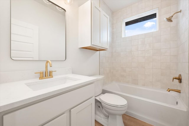 full bathroom with vanity, toilet, tiled shower / bath combo, and wood-type flooring