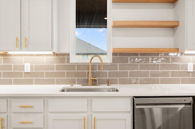 kitchen with white cabinetry, sink, tasteful backsplash, and stainless steel dishwasher