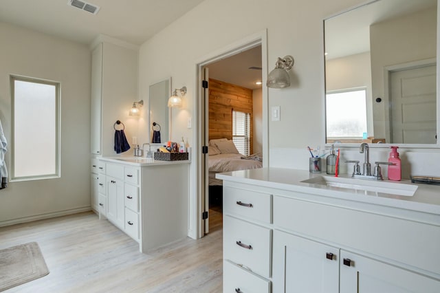 3713 128th St, Lubbock, TX 79423 - ensuite bathroom featuring vanity, wood finished floors, and wood walls