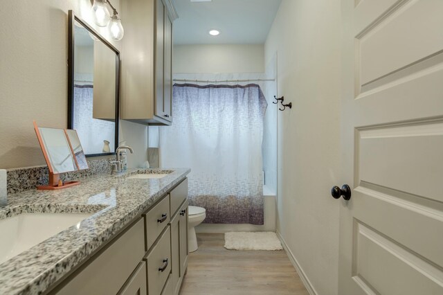 3713 128th St, Lubbock, TX 79423 - bathroom with wood finished floors, double vanity, shower / tub combo, and recessed lighting