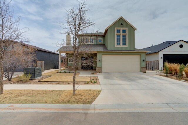 3713 128th St, Lubbock, TX 79423 - view of front of home with an attached garage, concrete driveway, board and batten siding, a chimney, and covered porch