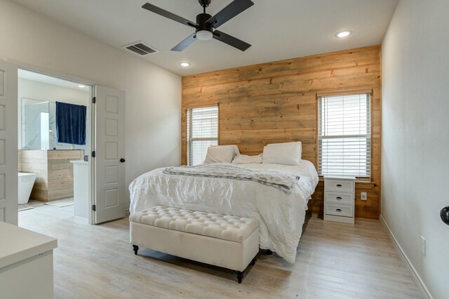 3713 128th St, Lubbock, TX 79423 - bedroom with light wood-style floors, wooden walls, recessed lighting, connected bathroom, and a ceiling fan