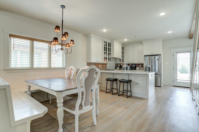 3713 128th St, Lubbock, TX 79423 - dining room featuring light wood finished floors, a chandelier, and recessed lighting
