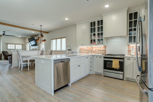 3713 128th St, Lubbock, TX 79423 - kitchen featuring stainless steel appliances, a peninsula, recessed lighting, open floor plan, and white cabinets