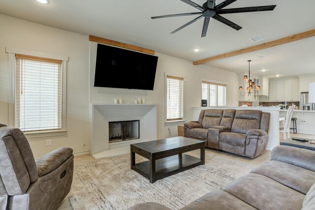 3713 128th St, Lubbock, TX 79423 - living area with ceiling fan, recessed lighting, a fireplace, beam ceiling, and light wood finished floors