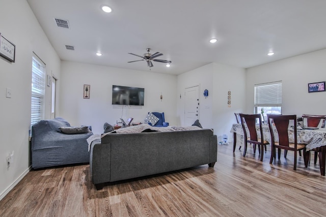 living room with ceiling fan and hardwood / wood-style floors