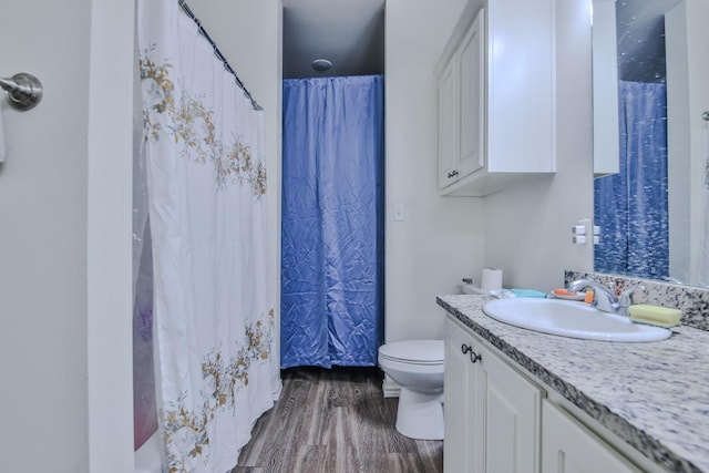 bathroom with vanity, hardwood / wood-style floors, toilet, and a shower with shower curtain