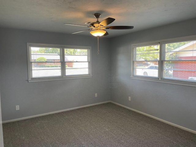 carpeted spare room with ceiling fan