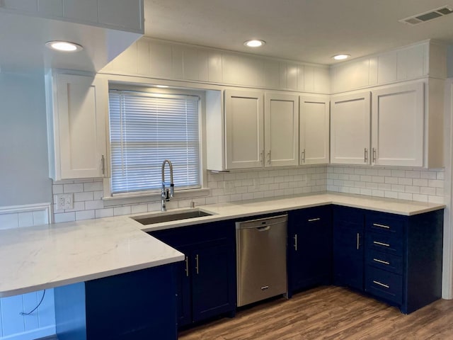 kitchen with white cabinetry, dishwasher, and sink