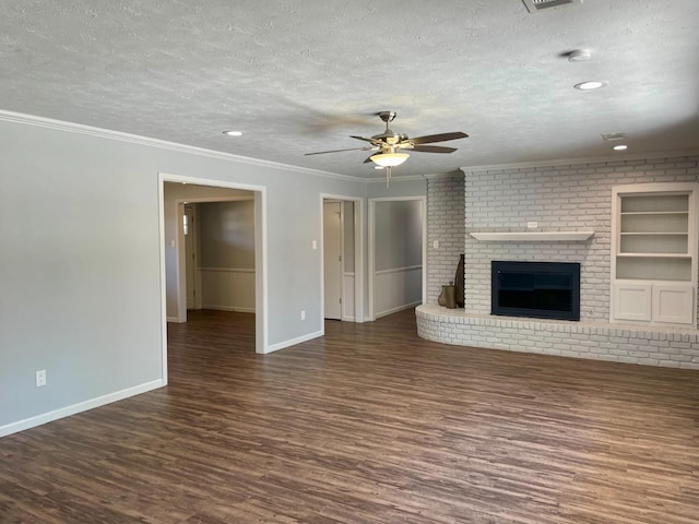 unfurnished living room with a fireplace, dark hardwood / wood-style flooring, ornamental molding, ceiling fan, and a textured ceiling