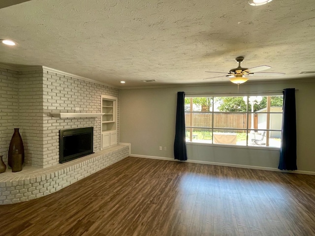 unfurnished living room featuring hardwood / wood-style flooring and a textured ceiling