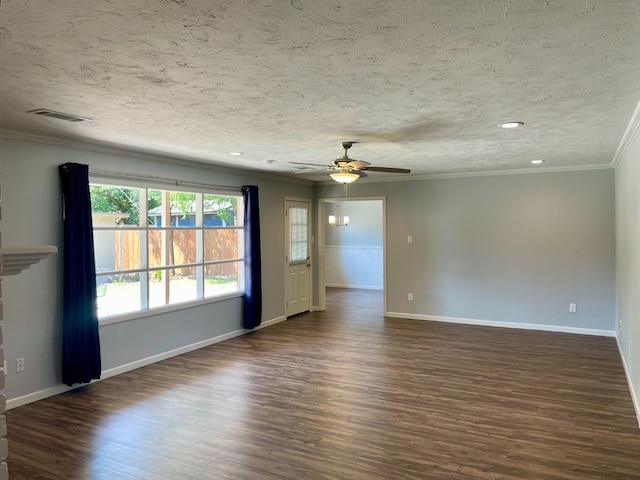 spare room featuring ornamental molding, dark hardwood / wood-style floors, and a textured ceiling