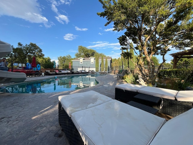 view of swimming pool featuring a patio area