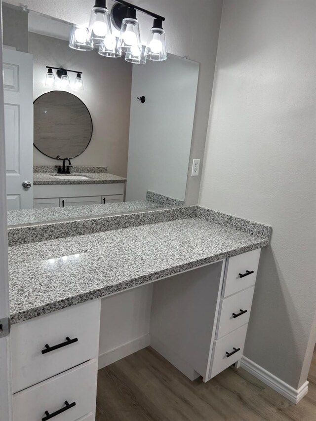 bathroom with vanity, hardwood / wood-style floors, and a chandelier