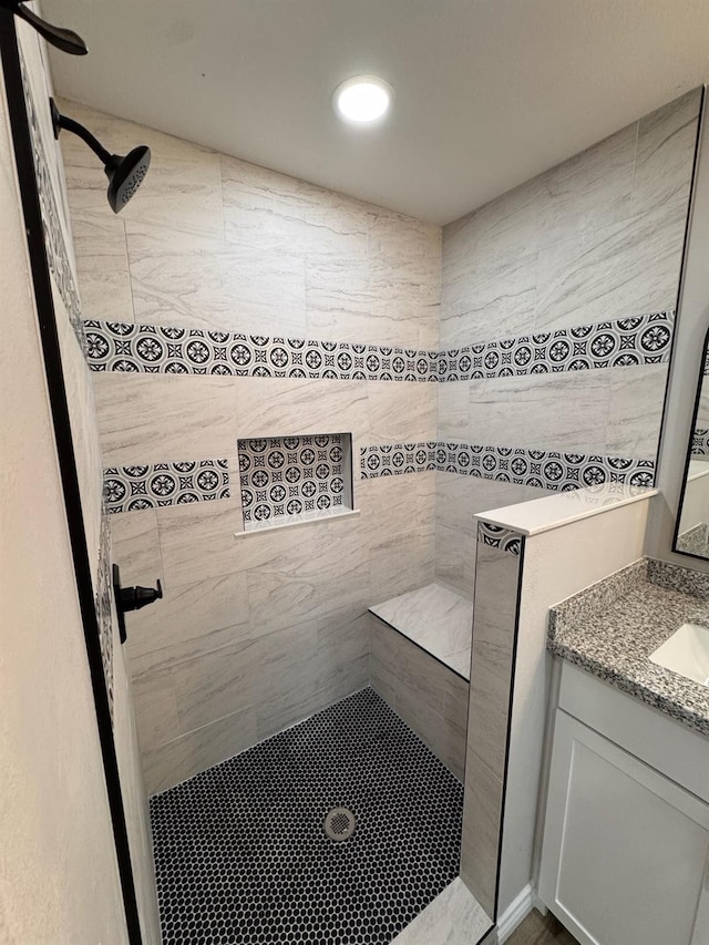 bathroom with vanity and tiled shower