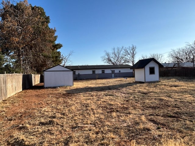 back of property with a storage shed